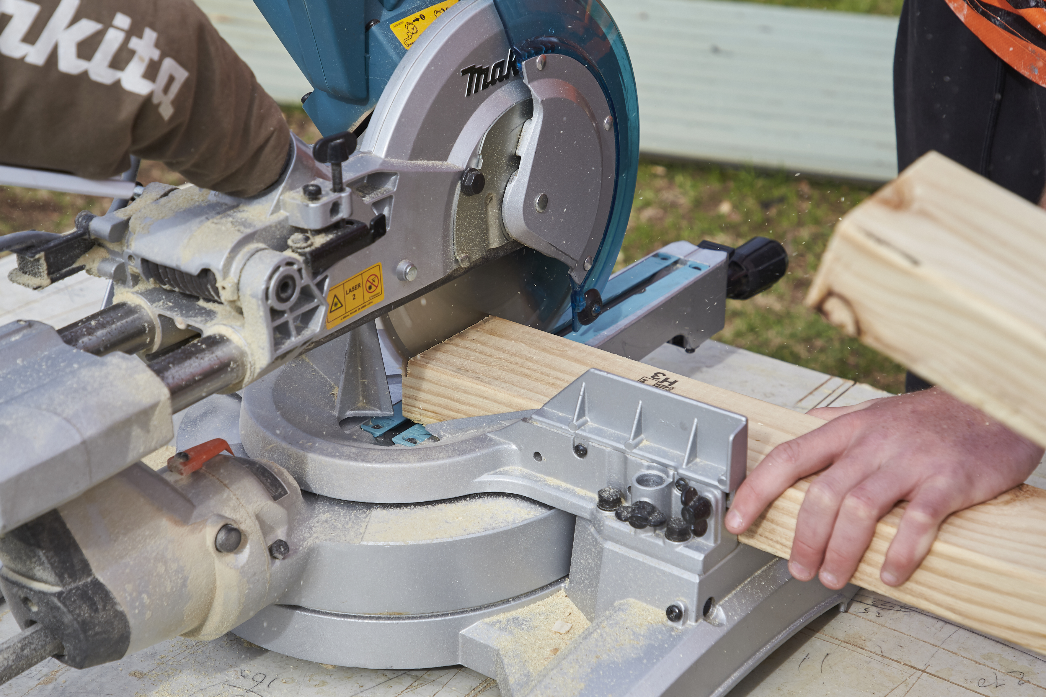 Carpentry student using saw.