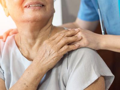 A carer comforting an older lady