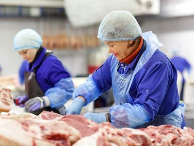 Two meat processing workers on the job