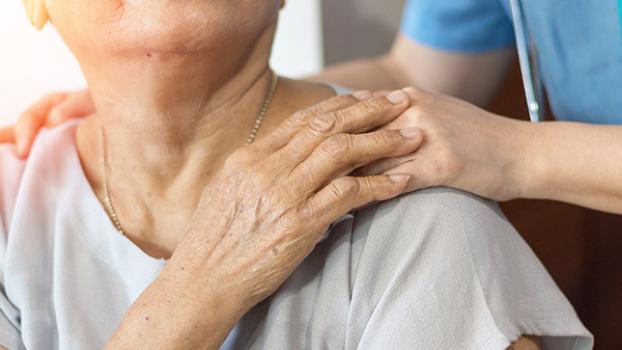 A carer comforting an older lady