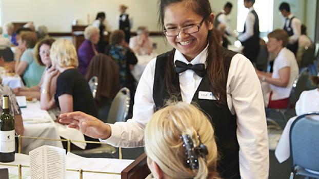 Female waitress taking an order in a restaurant.