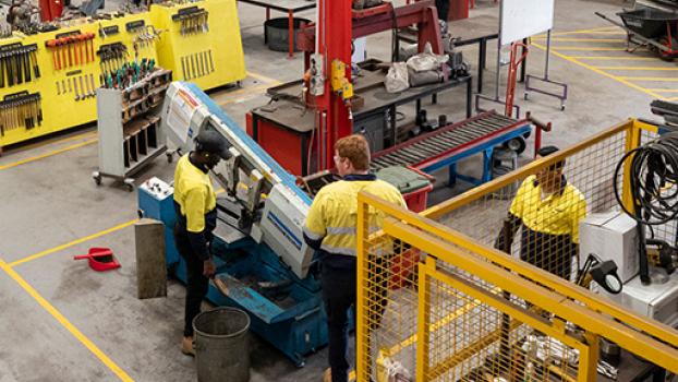 Engineering workshop with two male workers.