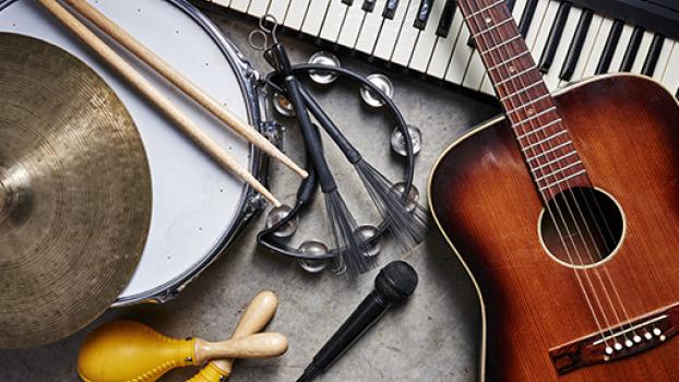 Collection of musicla instruments, guitar, drums, keyboard.