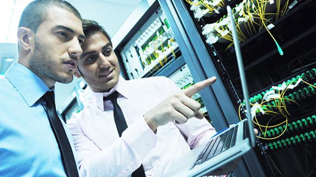 Two network engineers in server room