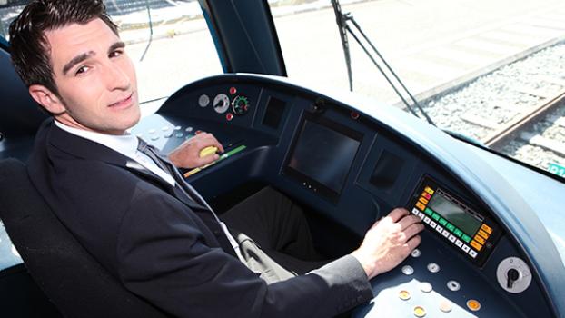 Train driver at console of train