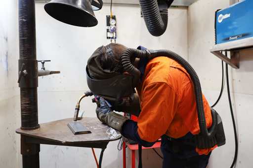 person in full protective outfit working