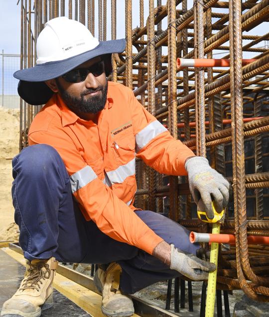 Civil construction worker holding tools. 