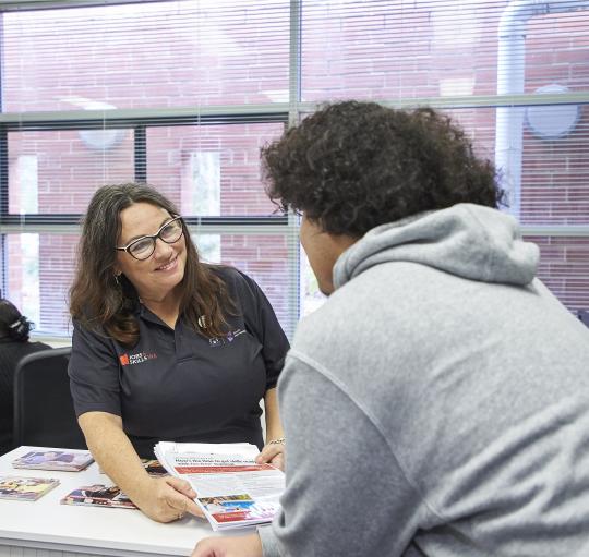 JCS staff talking to student.