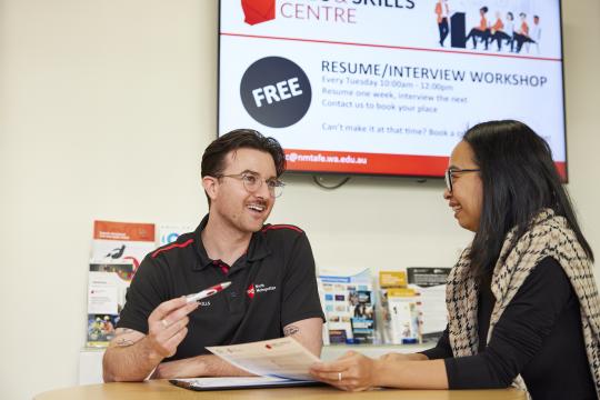 JSC staff member talking to a student.
