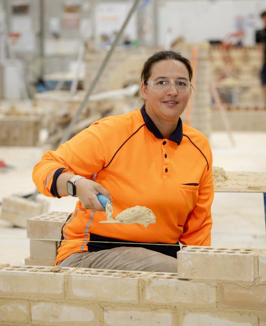 Bricklaying laying bricks.