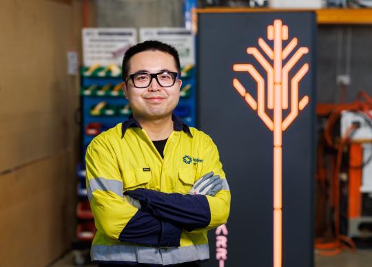 Electrician smiling at camera.
