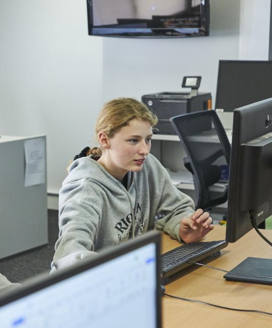 Student sitting in front of computer.
