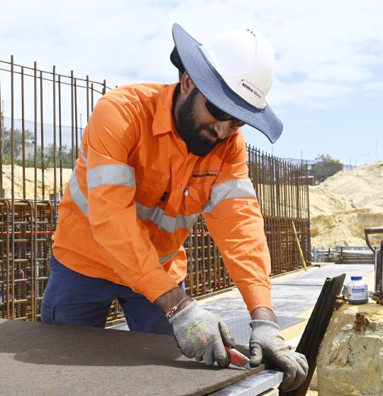 Civil construction worker using tools.