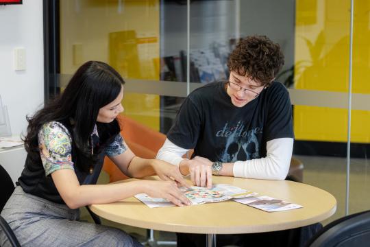 JSC staff member helping student.