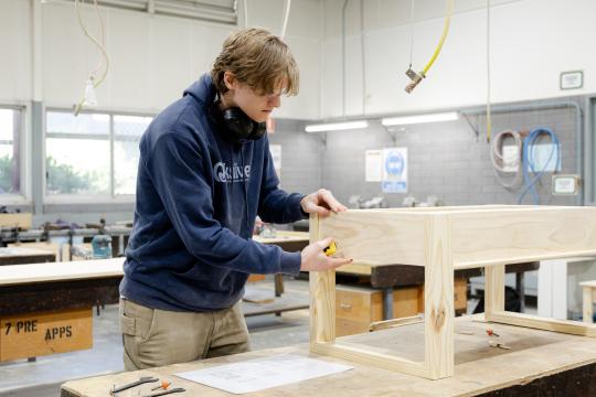 Cabinet maker student building cabinet.