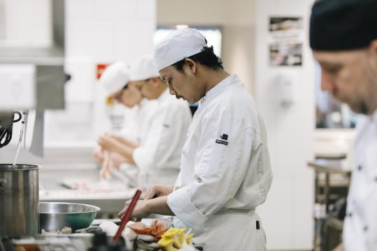 Chef student in kitchen.